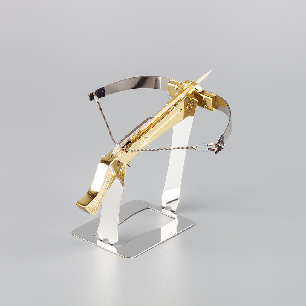 gold plated bowman crossbow on a stainless steel display stand