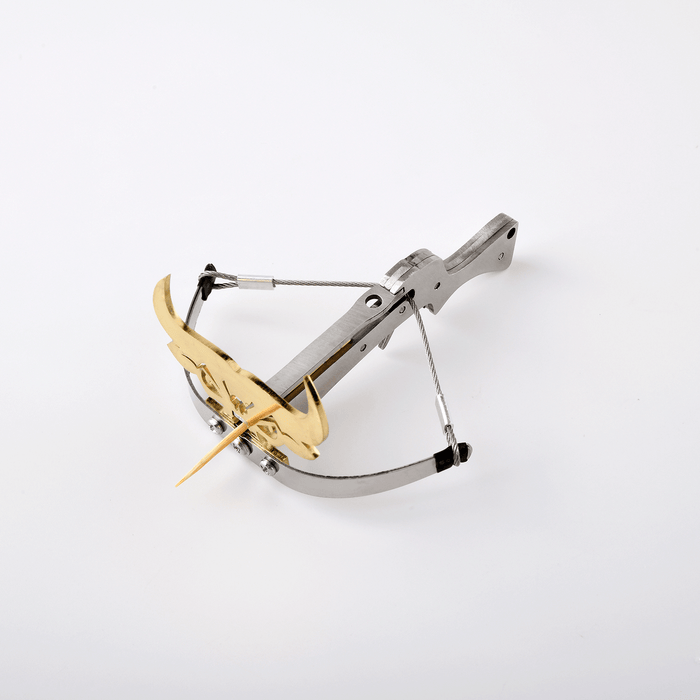 silver and gold toro bull metal crossbow loaded with toothpick