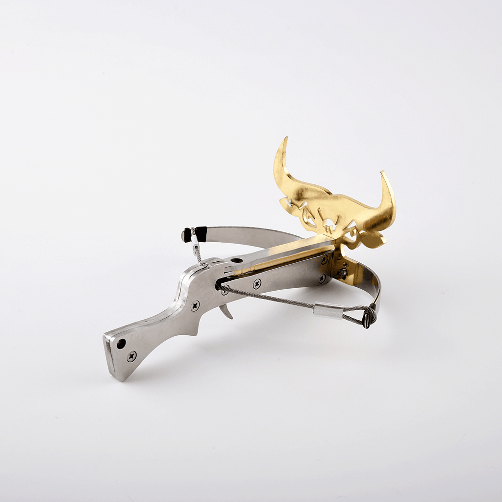 silver and gold toro bull metal crossbow loaded with toothpick